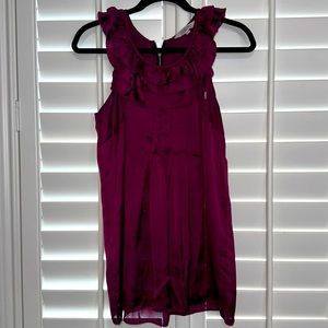 Cute flowy blouse with ruffle detail. Color is between purple/ dark pink